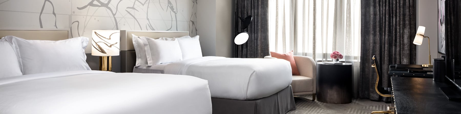 Bedroom with two queen beds and artwork on the wall