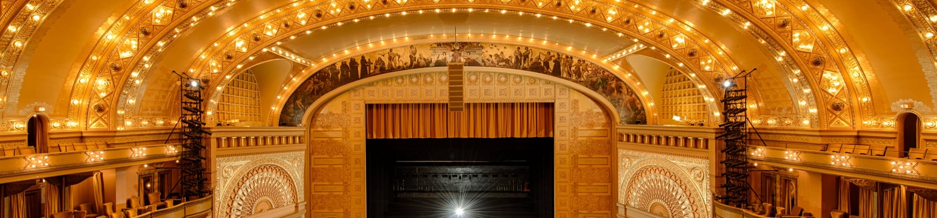 An interior view of a fully illuminated Chicago Theatre.