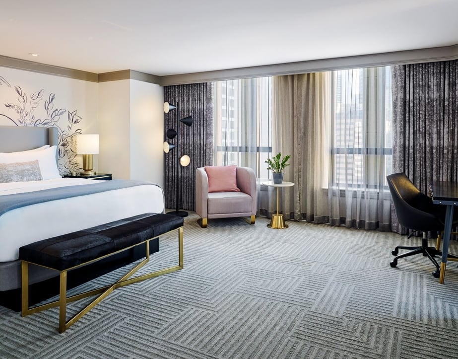Large Chicago hotel bedroom with sitting area and desk