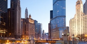 A view of the Chicago River and downtown buildings at dusk.