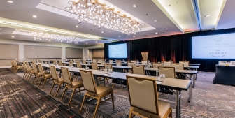 Rows of tables and chairs in a large meeting venue in The Gwen, a hotel in downtown Chicago.