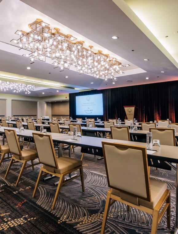 Rows of tables and chairs in a large meeting venue in The Gwen, a hotel in downtown Chicago.