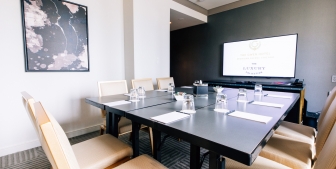 A meeting breakout room in The Gwen with a large HD TV.