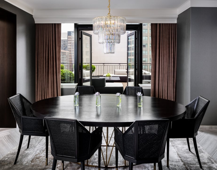 A large dining table with black chairs.