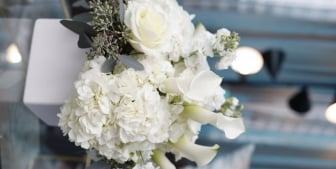 A large wedding bouquet with white and green flowers.