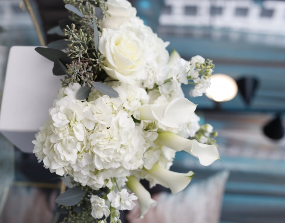 A large wedding bouquet with white and green flowers.