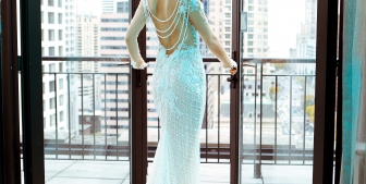 A bride opening french doors on the Gwen's balcony in downtown Chicago.