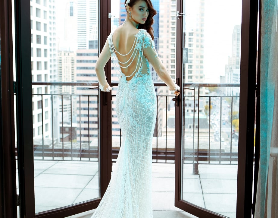 A bride opening french doors on the Gwen's balcony in downtown Chicago.