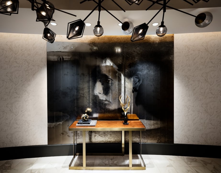 A wall painting of a woman's face in The Gwen's lobby.