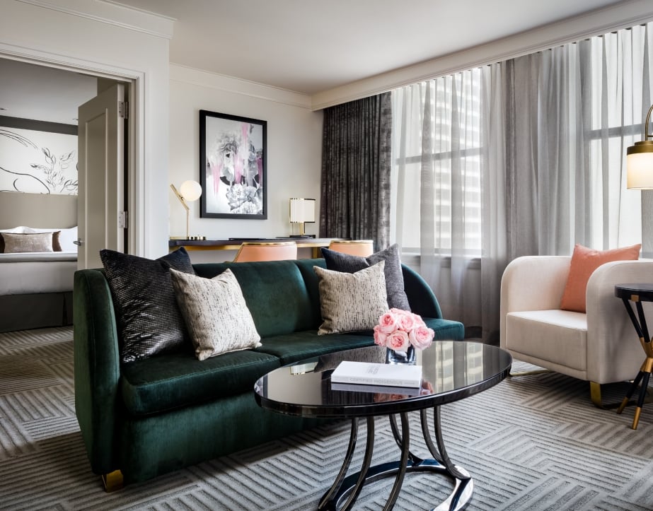 A green couch and small coffee table found in The Gwen's King Superior Suite