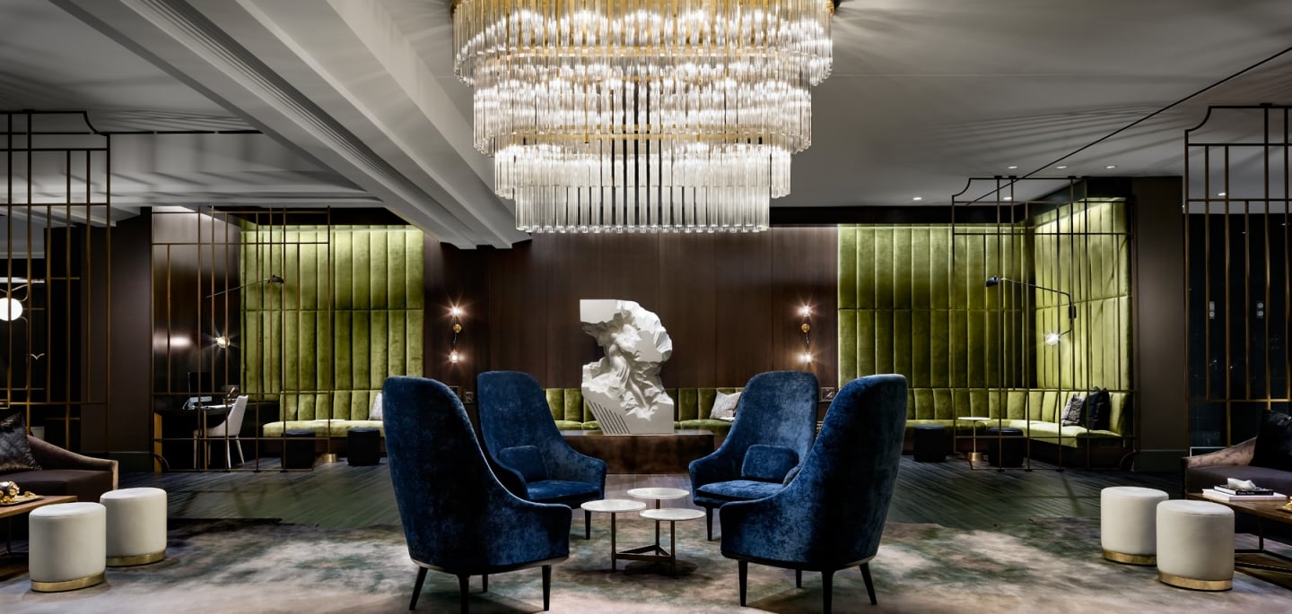 A large three-tiered chandelier in the lobby of The Gwen, a hotel in downtown Chicago.