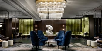 A large three-tiered chandelier in the lobby of The Gwen, a hotel in downtown Chicago.