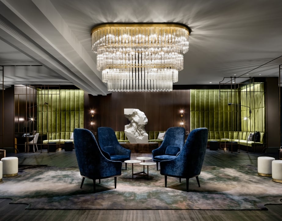 A large three-tiered chandelier in the lobby of The Gwen, a hotel in downtown Chicago.