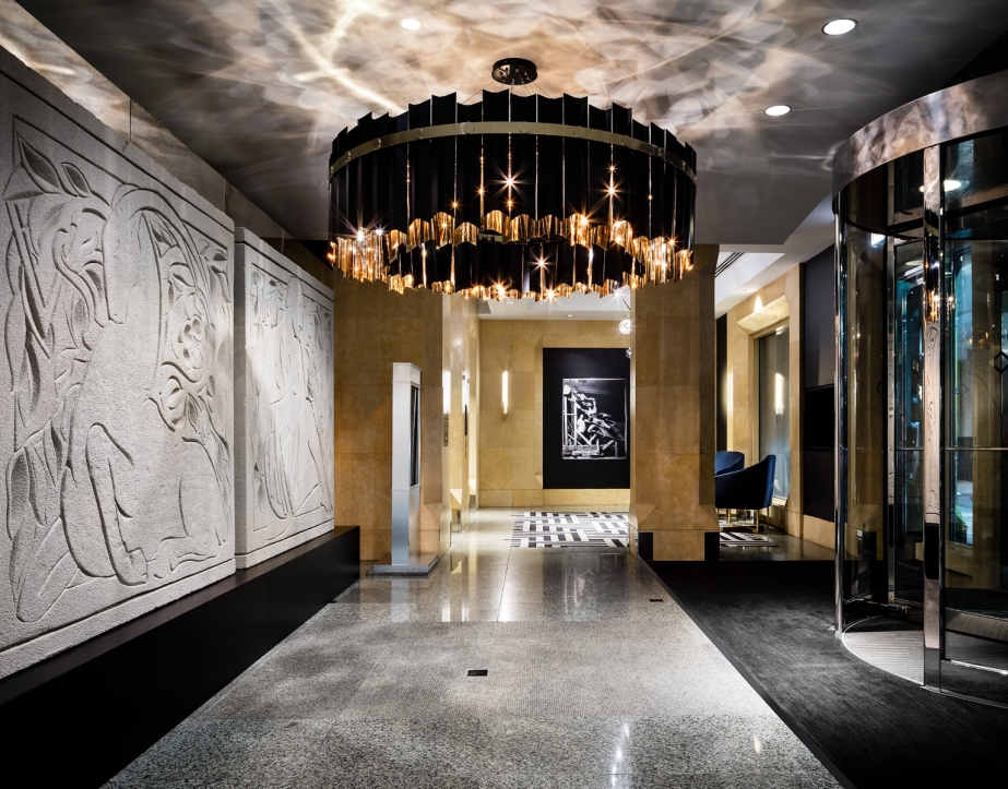 A large chandelier hanging in the lobby area of The Gwen.