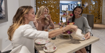 Three ladies enjoy drinks at The Gwen's tipsy tea party.