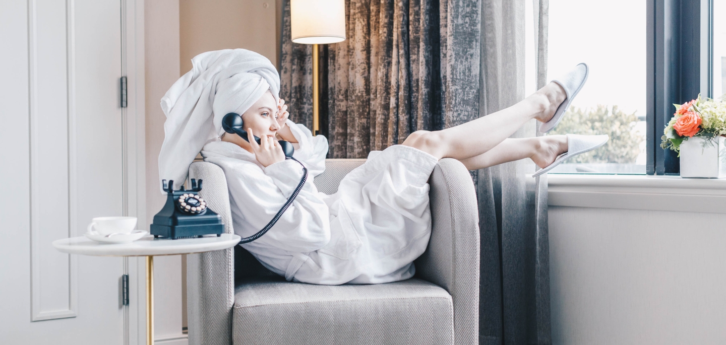 Girl Ordering Room Service in Room in Gwen Suite