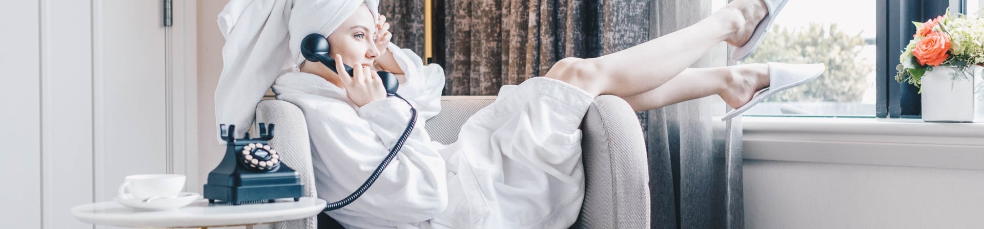 Girl Ordering Room Service in Room in Gwen Suite